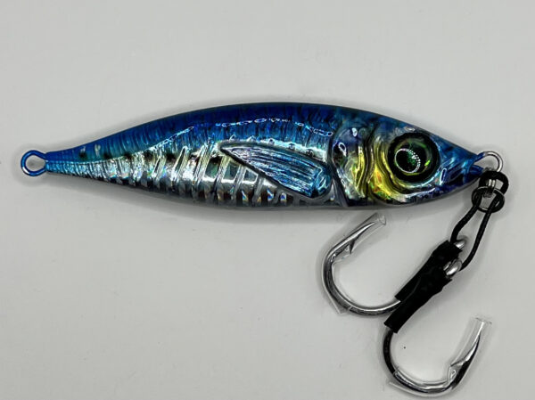 A Striper-Gear 3D Jigs metal fishing lures pictured in a blue metallic color is pictured on its side to show off its reflective properties and realistic color