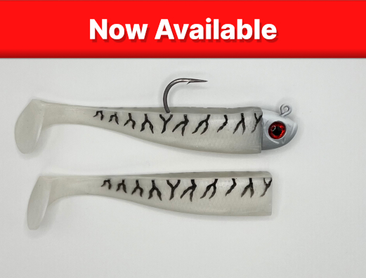 Image of the 2oz beach shaddy daddy soft plastic lure in the ghost color with a banner saying 'Now Available'. There is also an extra tail pictured as the Beach Shaddy Daddy includes an extra tail.